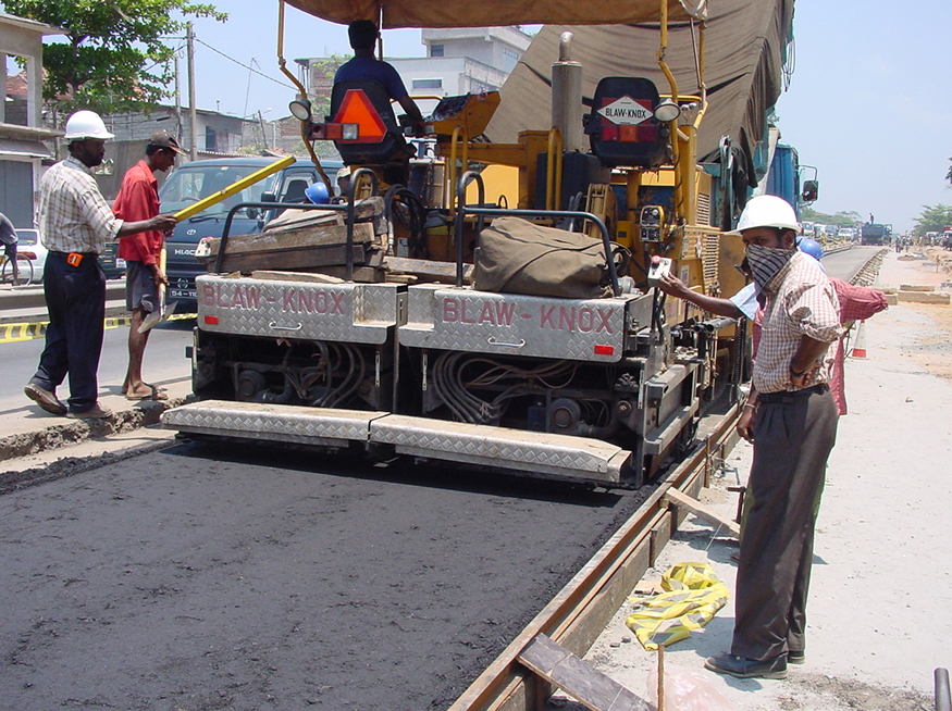 Laying Asphalt regulating and wearing courses On 5 kms.