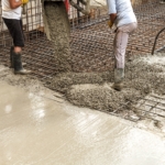 Pouring concrete into the construction of the house. Builders are pouring ready-mixed concrete